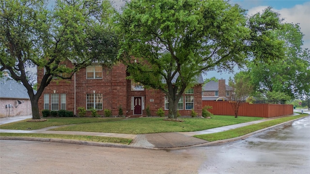 2325 Heather Ridge Dr, Flower Mound, TX 75028 - view of front facade with fence, a front lawn, and brick siding