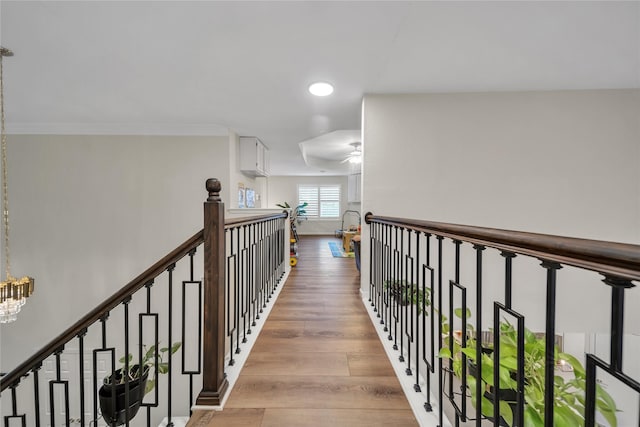 2325 Heather Ridge Dr, Flower Mound, TX 75028 - hall featuring an upstairs landing, an inviting chandelier, ornamental molding, and wood finished floors