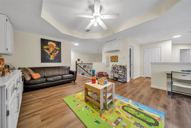 2325 Heather Ridge Dr, Flower Mound, TX 75028 - living area with ceiling fan, attic access, a raised ceiling, light wood finished floors, and baseboards