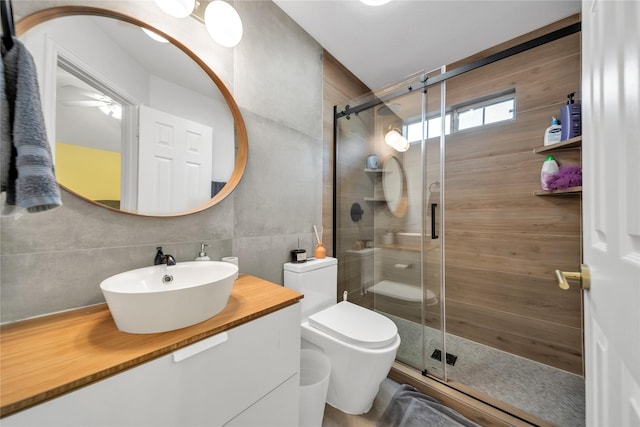 2325 Heather Ridge Dr, Flower Mound, TX 75028 - bathroom featuring tile walls, toilet, vanity, backsplash, and a stall shower