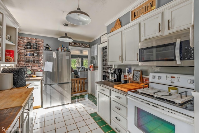 kitchen with stainless steel appliances, wood counters, crown molding, and light tile patterned flooring