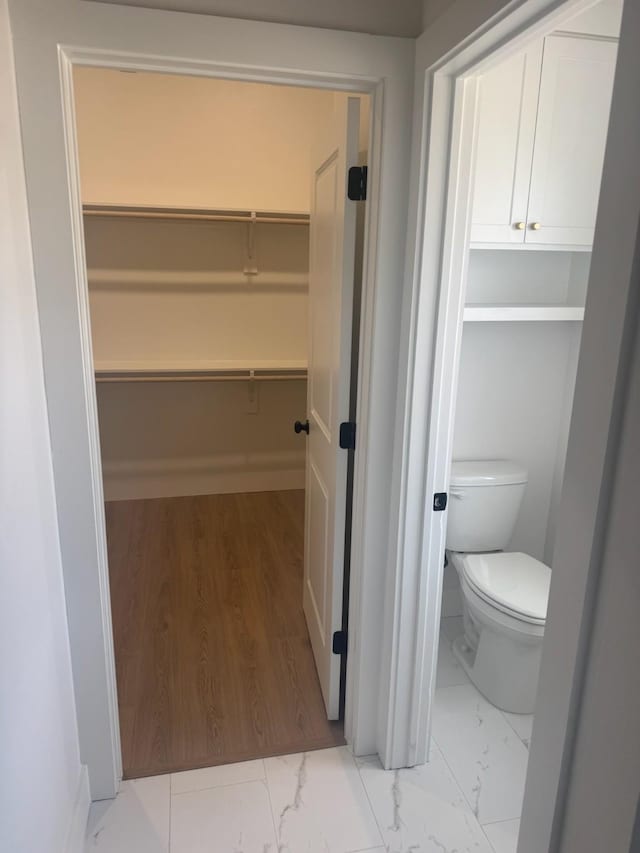608 N Mill St, Weatherford, TX 76086 - bathroom with marble finish floors and toilet