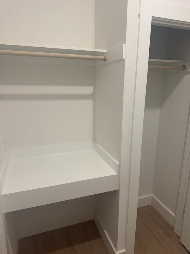 bathroom with a sink, baseboards, double vanity, and marble finish floor