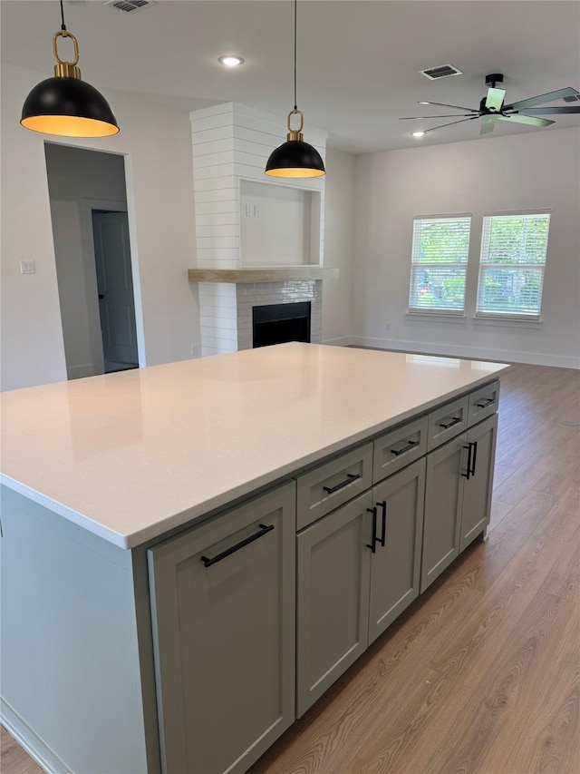 608 N Mill St, Weatherford, TX 76086 - kitchen with gray cabinetry, light wood finished floors, open floor plan, ceiling fan, and recessed lighting