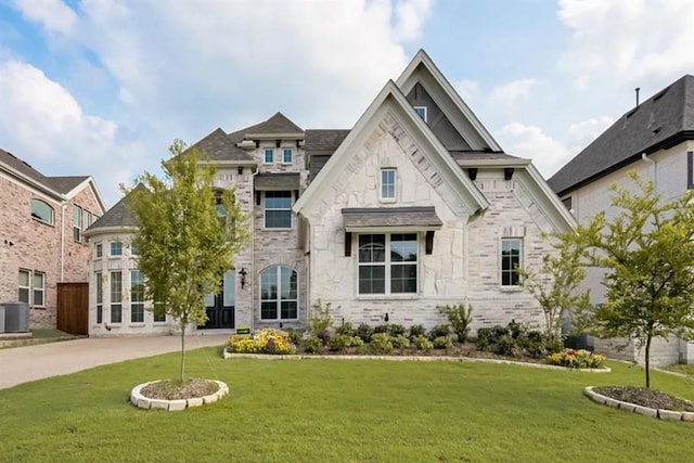 5412 Glenscape Cir, Plano, TX 75094 - french country style house featuring a front yard, central air condition unit, and stone siding