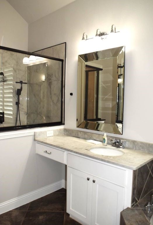 bathroom with a walk in shower and vanity