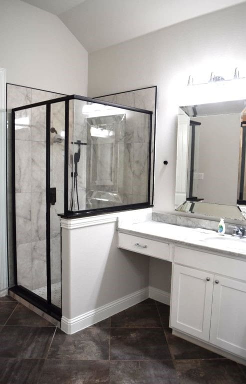 full bath with a shower stall and vanity