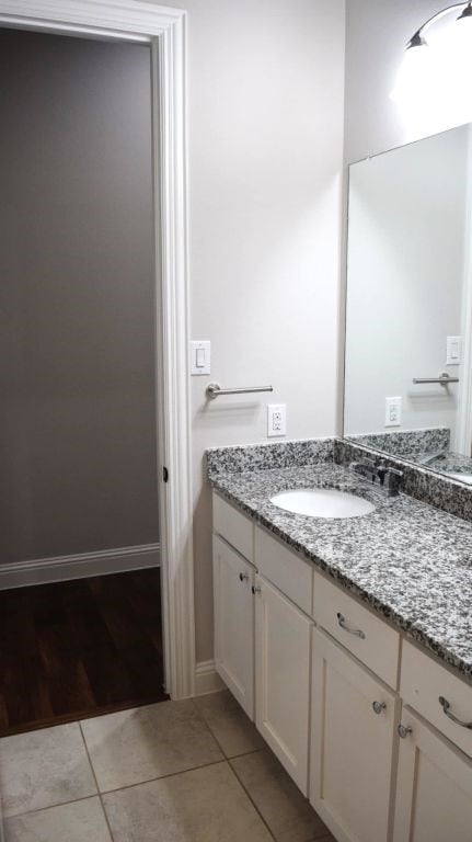 bathroom featuring tile patterned floors, vanity, and baseboards