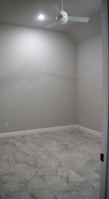 unfurnished room with recessed lighting, baseboards, and vaulted ceiling