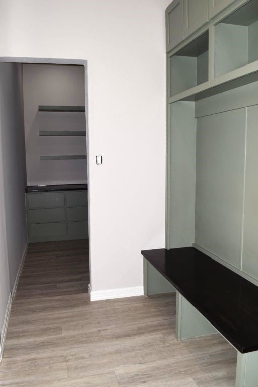 mudroom with light wood-type flooring and baseboards