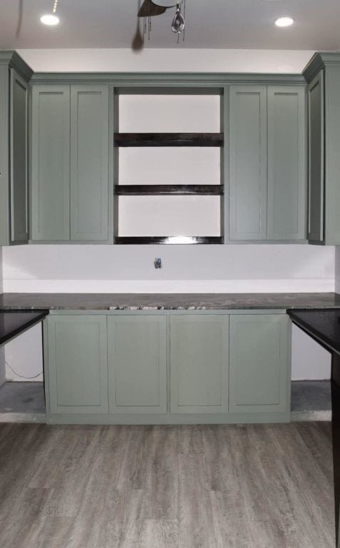 kitchen with green cabinets and light wood finished floors