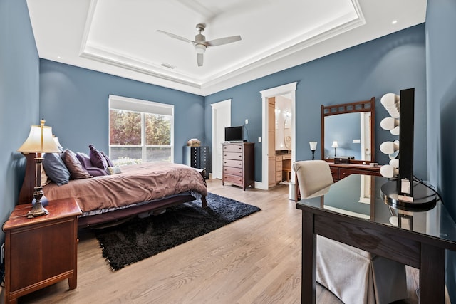 2286 White Stag Rd, Celina, TX 75009 - bedroom with a tray ceiling, light wood-style floors, ensuite bath, and ceiling fan