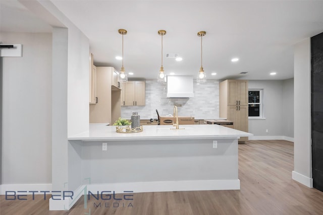 11006 Ferndale Rd, Dallas, TX 75238 - kitchen with light wood-style flooring, a sink, light countertops, a peninsula, and decorative backsplash