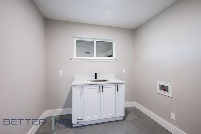 11006 Ferndale Rd, Dallas, TX 75238 - laundry area with baseboards, a sink, dark tile patterned floors, cabinet space, and hookup for a washing machine