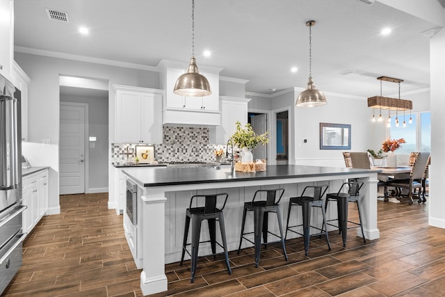 5685 Florance Rd, Northlake, TX 76247 - kitchen with dark wood-style floors, dark countertops, recessed lighting, baseboards, and backsplash