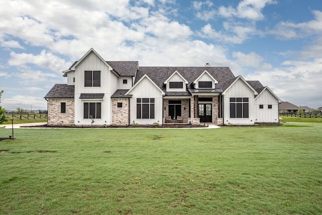5685 Florance Rd, Northlake, TX 76247 - back of property with board and batten siding, a lawn, a standing seam roof, and roof with shingles