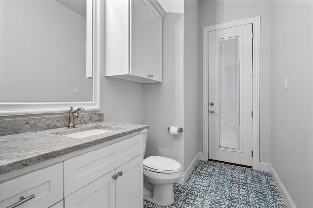 5685 Florance Rd, Northlake, TX 76247 - half bathroom featuring vanity, toilet, baseboards, and tile patterned flooring