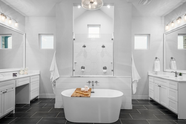 5685 Florance Rd, Northlake, TX 76247 - bathroom with tile patterned flooring, a freestanding tub, two vanities, and healthy amount of natural light