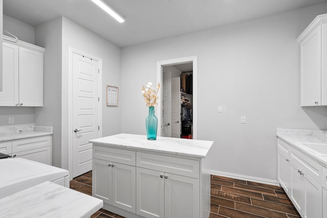 5685 Florance Rd, Northlake, TX 76247 - kitchen featuring wood finish floors, white cabinetry, a sink, and light stone countertops