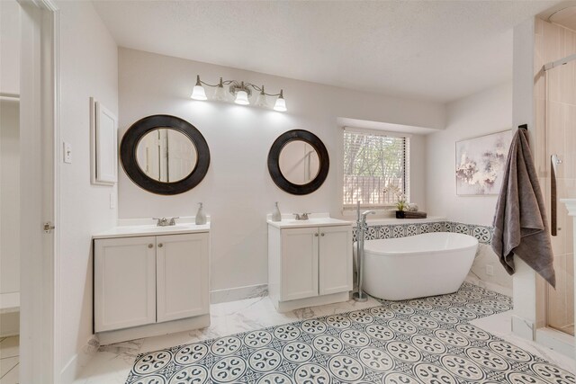820 Craig Dr, Mesquite, TX 75181 - full bath with marble look tile flooring, two vanities, a soaking tub, and a shower
