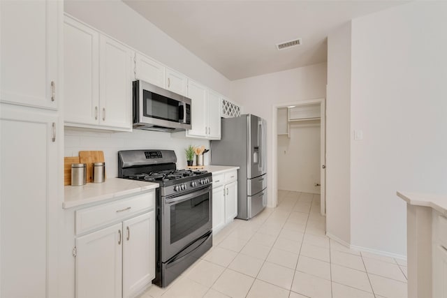 820 Craig Dr, Mesquite, TX 75181 - kitchen with appliances with stainless steel finishes, white cabinetry, light countertops, light tile patterned floors, and baseboards