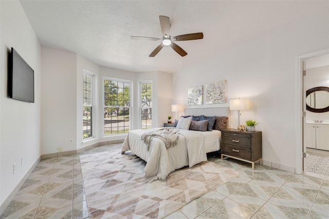 820 Craig Dr, Mesquite, TX 75181 - bedroom with light tile patterned floors, ensuite bathroom, baseboards, and ceiling fan