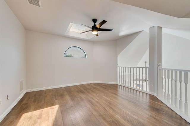 820 Craig Dr, Mesquite, TX 75181 - unfurnished room with a ceiling fan, a skylight, wood finished floors, and baseboards