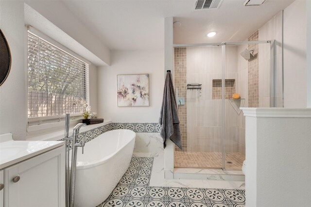 820 Craig Dr, Mesquite, TX 75181 - bathroom with a freestanding tub, a stall shower, vanity, tile patterned flooring, and recessed lighting