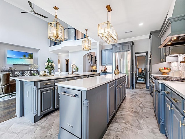 kitchen featuring premium appliances, light countertops, visible vents, a center island, and open floor plan