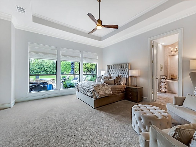 carpeted bedroom featuring a ceiling fan, a tray ceiling, baseboards, ornamental molding, and visible vents