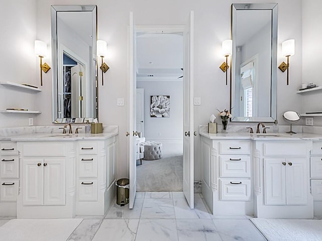 bathroom with marble finish floor, two vanities, and a sink