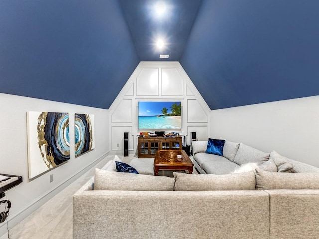 carpeted living room featuring vaulted ceiling and baseboards