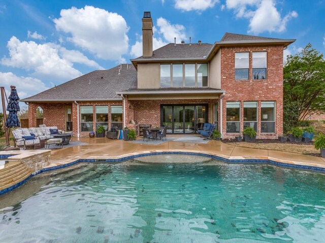 rear view of house featuring a chimney, an outdoor pool, a patio area, an outdoor living space, and brick siding