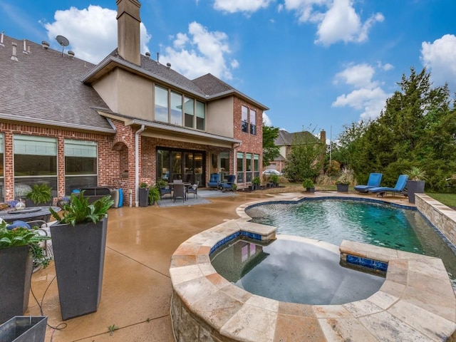 view of pool featuring a pool with connected hot tub and a patio