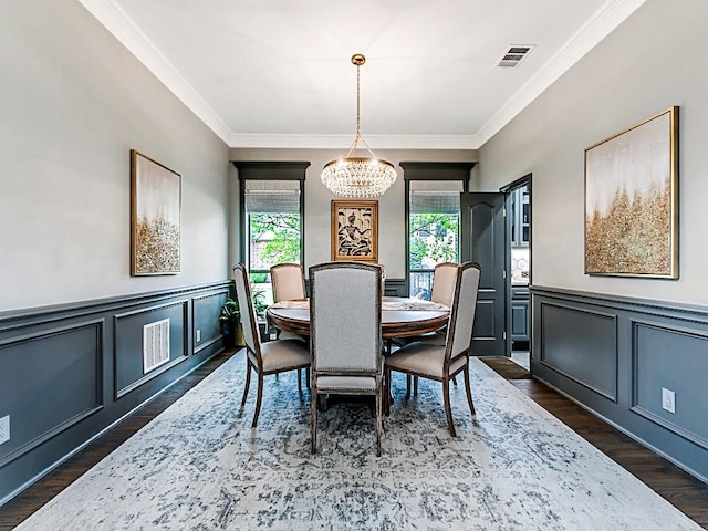 dining room featuring a wealth of natural light, a notable chandelier, visible vents, and a decorative wall