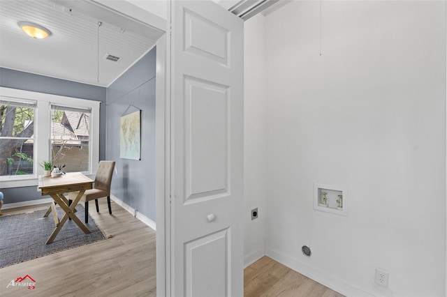 interior space featuring laundry area, hookup for a washing machine, light wood-style flooring, visible vents, and hookup for an electric dryer