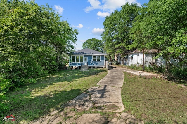 bungalow-style house with a front lawn