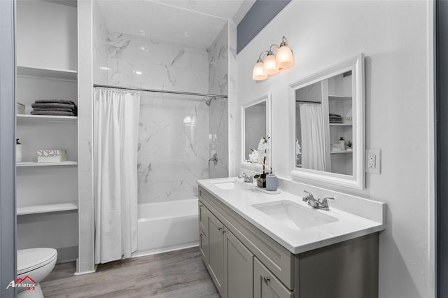 full bathroom featuring shower / bath combination with curtain, a sink, toilet, double vanity, and wood finished floors