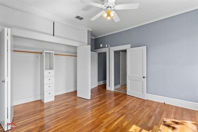 unfurnished bedroom with crown molding, ceiling fan, light wood-style flooring, visible vents, and baseboards