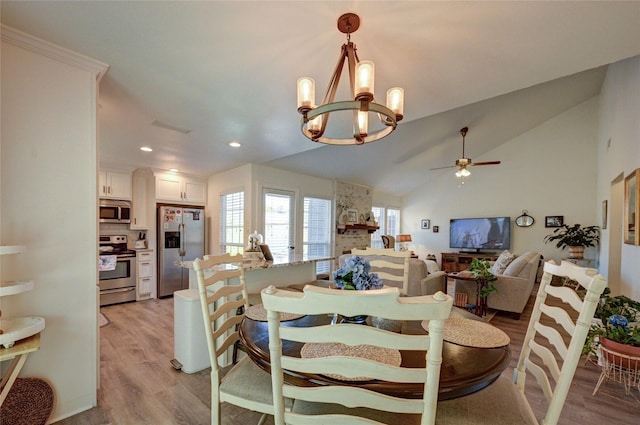 2109 Windy Dr, Garland, TX 75044 - dining area featuring ceiling fan with notable chandelier, light wood-style flooring, visible vents, recessed lighting, and lofted ceiling