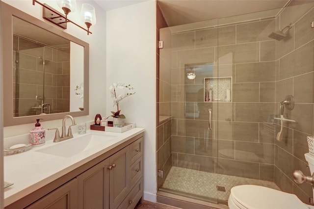 2109 Windy Dr, Garland, TX 75044 - bathroom featuring toilet, vanity, and a stall shower