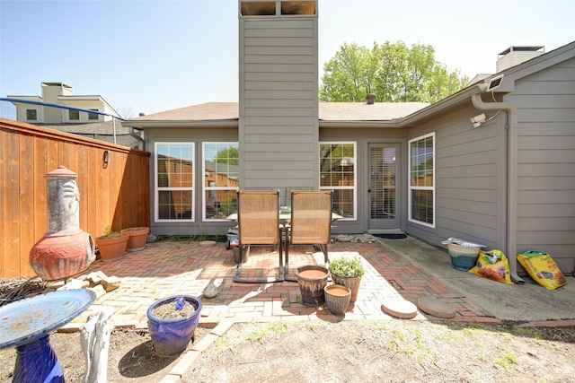 2109 Windy Dr, Garland, TX 75044 - back of property featuring fence, a patio, outdoor dining area, and a chimney