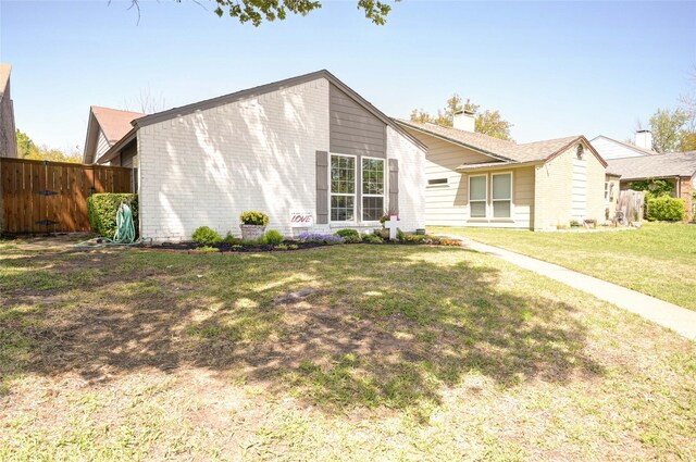 2109 Windy Dr, Garland, TX 75044 - mid-century inspired home featuring brick siding, a front lawn, fence, and a chimney