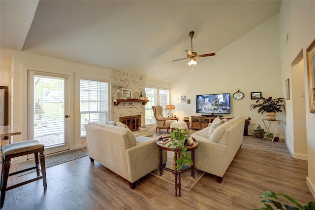 2109 Windy Dr, Garland, TX 75044 - living room with ceiling fan, high vaulted ceiling, wood finished floors, a brick fireplace, and baseboards