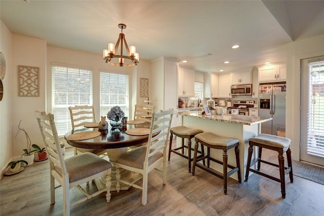2109 Windy Dr, Garland, TX 75044 - dining room with a wealth of natural light, recessed lighting, dark wood-style floors, and an inviting chandelier