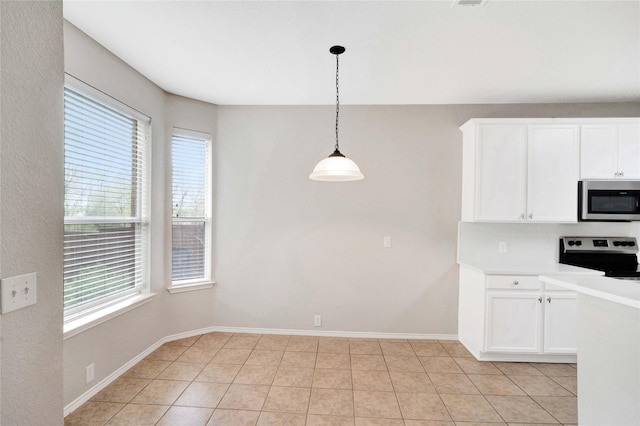 8625 Luzerne Dr, Mckinney, TX 75072 - kitchen featuring light tile patterned floors, light countertops, white cabinets, stainless steel appliances, and hanging light fixtures