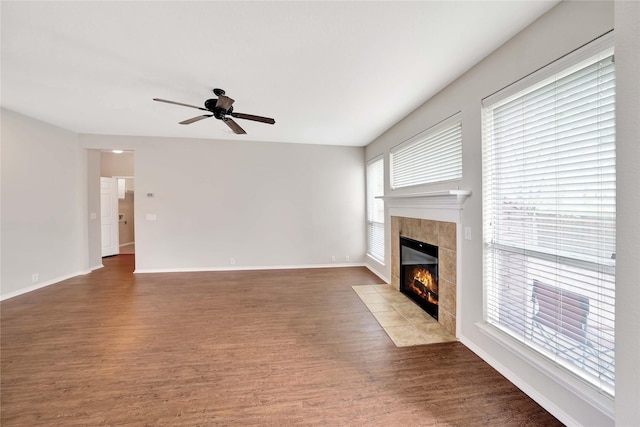 8625 Luzerne Dr, Mckinney, TX 75072 - unfurnished living room featuring baseboards, wood finished floors, a tile fireplace, and a ceiling fan