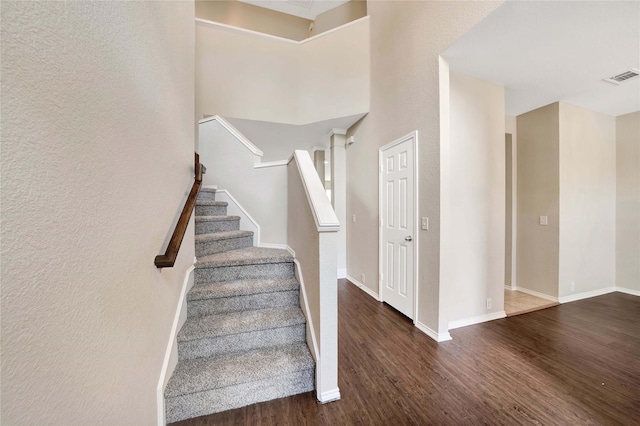 8625 Luzerne Dr, Mckinney, TX 75072 - stairway featuring a textured wall, visible vents, baseboards, and wood finished floors