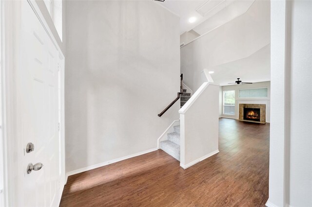 8625 Luzerne Dr, Mckinney, TX 75072 - stairway with baseboards, a tile fireplace, ceiling fan, and wood finished floors