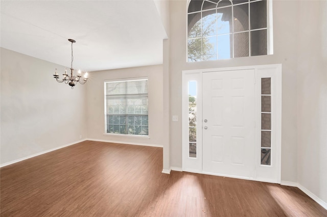 8625 Luzerne Dr, Mckinney, TX 75072 - entryway featuring baseboards, an inviting chandelier, and wood finished floors